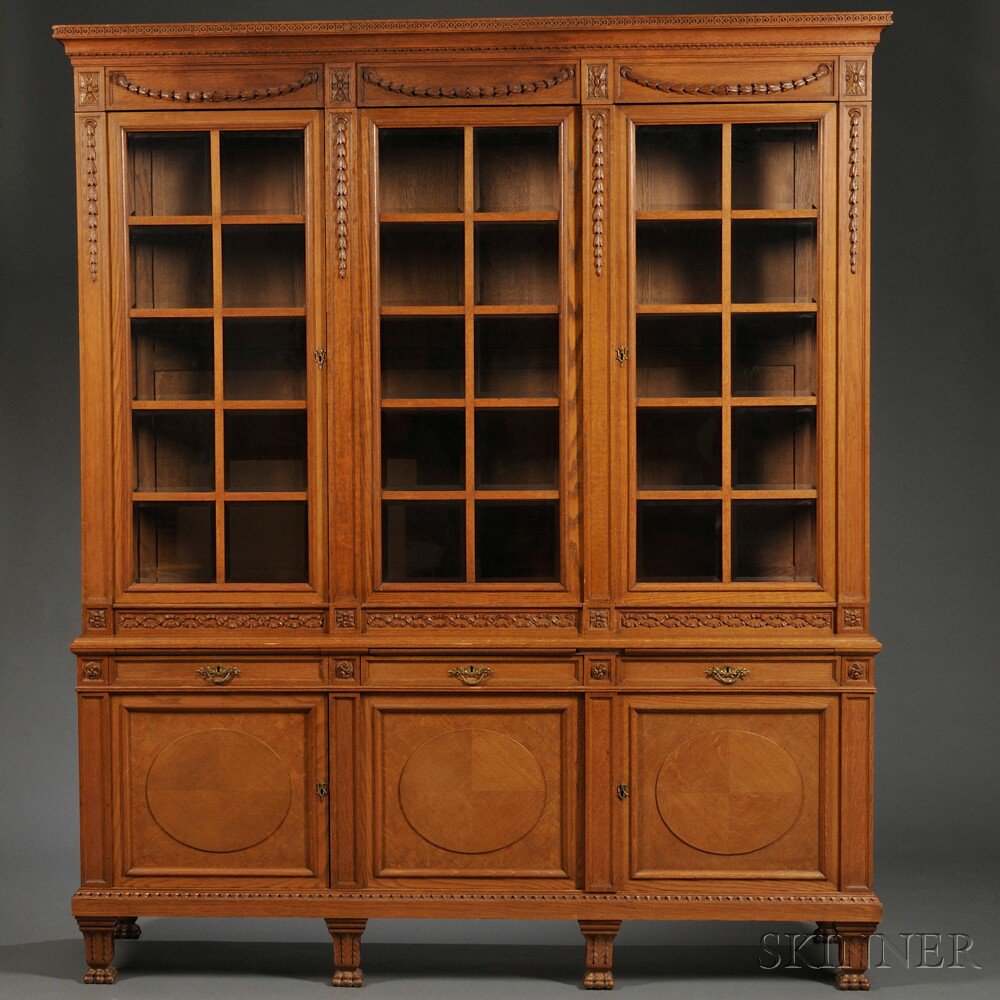 Appraisal: Neoclassical-style Carved Oak and Parquetry Bookcase th century with a