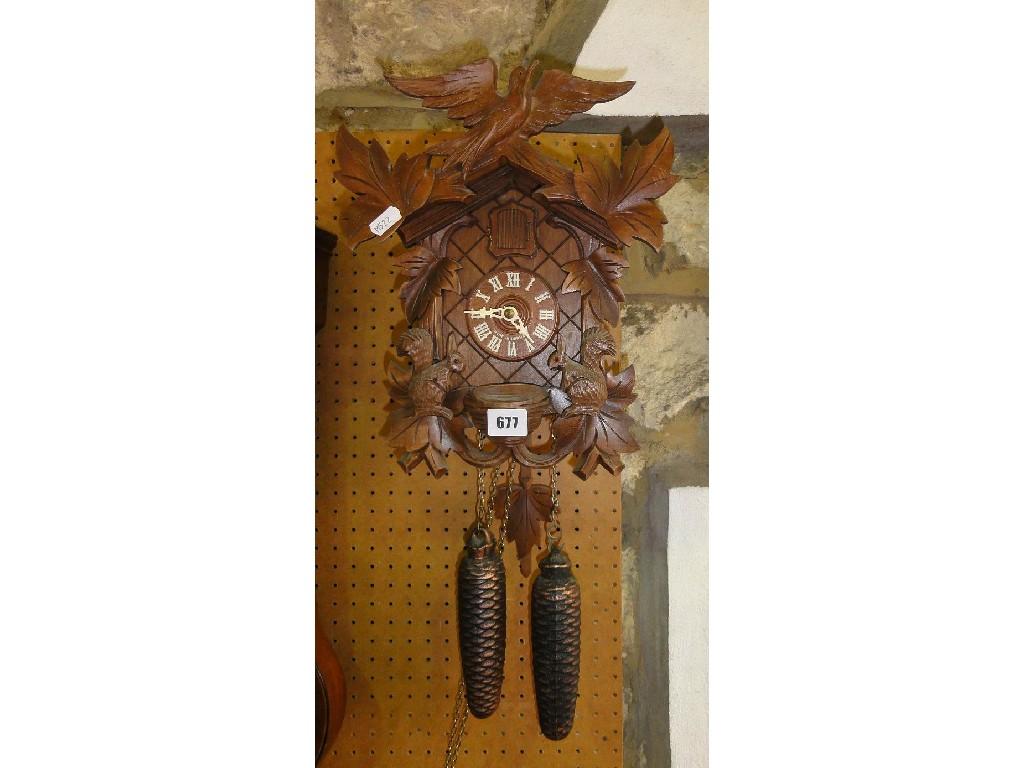 Appraisal: A German cuckoo clock of usual chalet form surmounted by