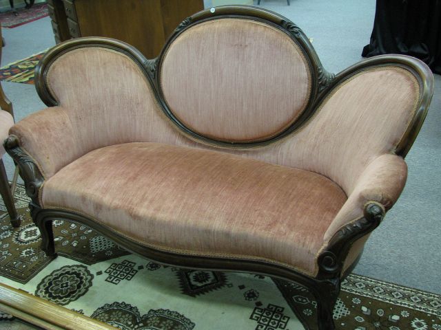 Appraisal: Victorian walnut settee with rose-colored upholstery on casters Medallion Back