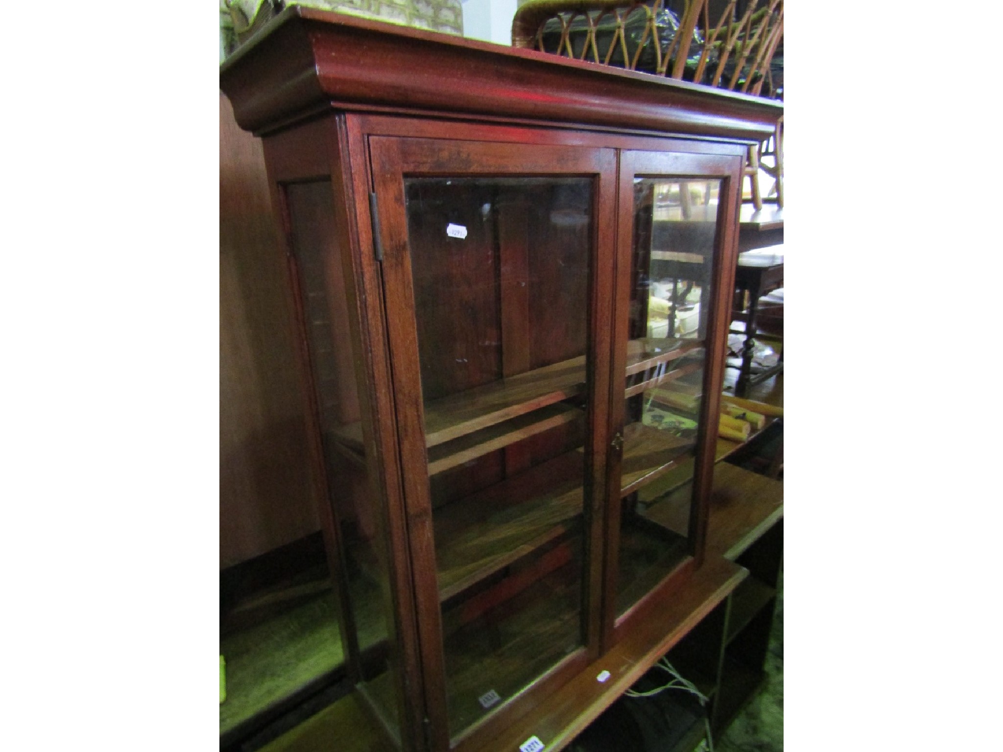 Appraisal: A mahogany wall mounted display cabinet enclosed by a pair