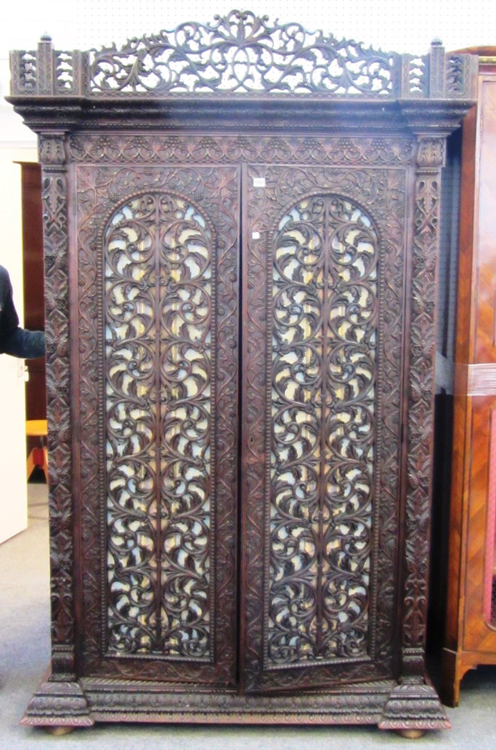 Appraisal: A th century Anglo Indian profusely carved teak two door