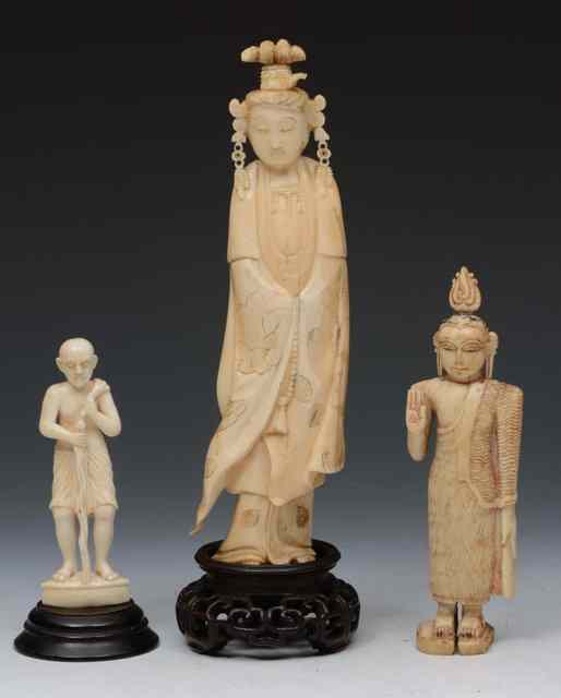 Appraisal: A CHINESE CARVED IVORY MODEL OF GUANYIN and two Burmese