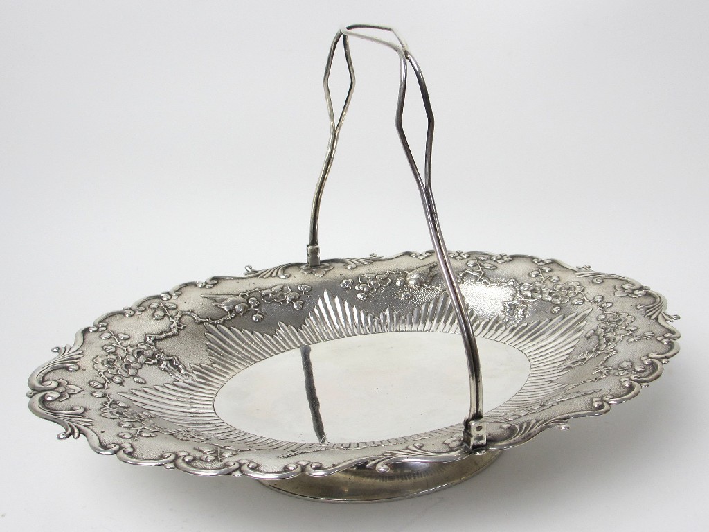 Appraisal: An East Asian white metal oval cake basket with swing