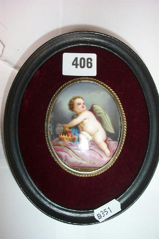 Appraisal: An oval ceramic panel with painted decoration of a cherub