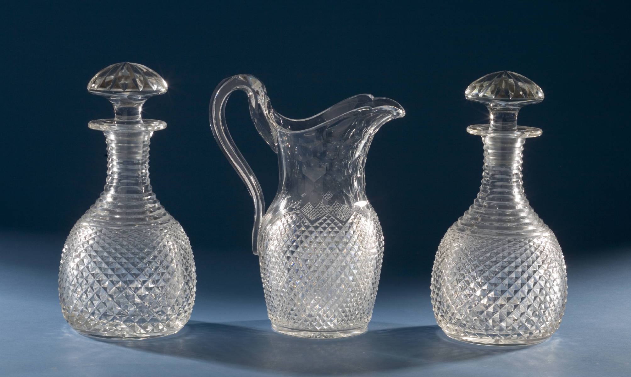 Appraisal: PAIR OF ANGLO-IRISH DIAMOND CUT GLASS DECANTERS AND A WATER