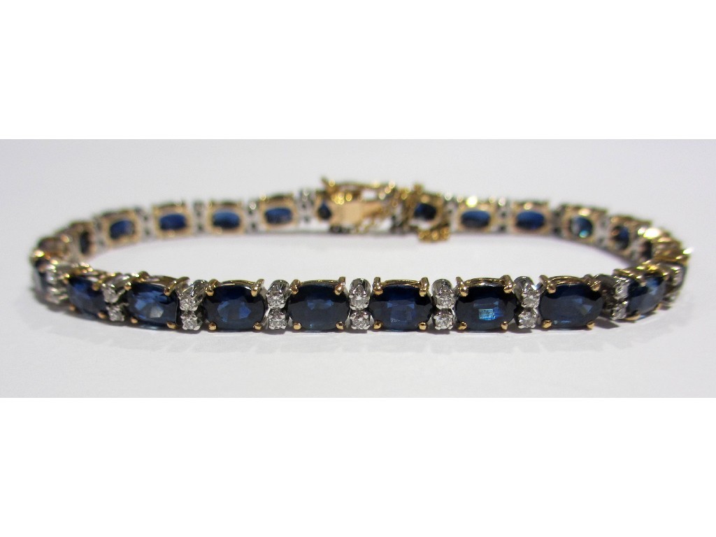 Appraisal: A sapphire and diamond line bracelet set with twenty three