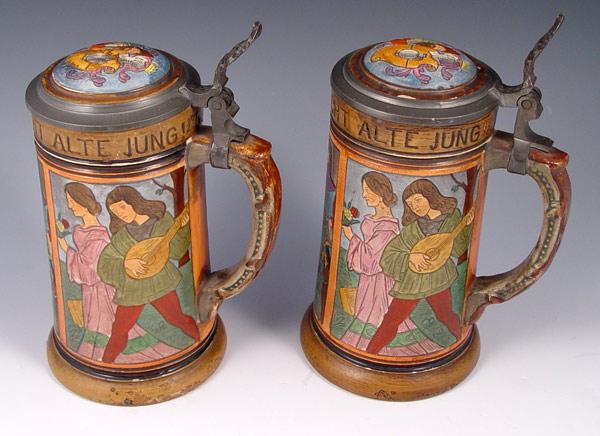 Appraisal: PAIR GERMAN BEER STEINS panel incised renaissance scenes with motto