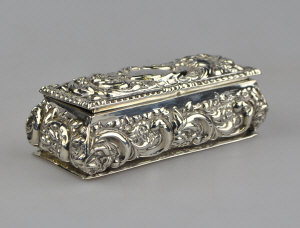 Appraisal: An Edwardian embossed silver ring box of bombe form with