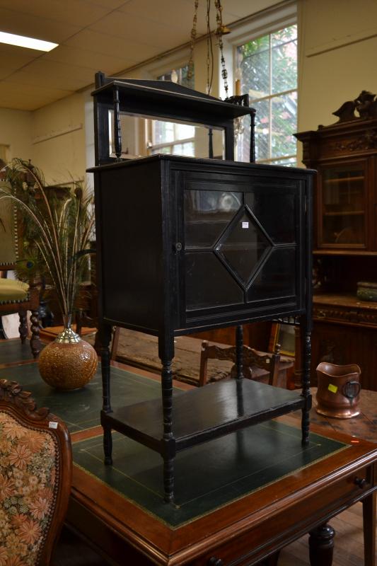 Appraisal: AN EBONISED GLAZED MIRROR BACKED CABINET AN EBONISED GLAZED MIRROR