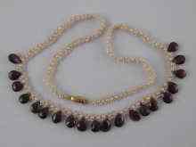 Appraisal: A garnet and seed pearl necklace approx cm long