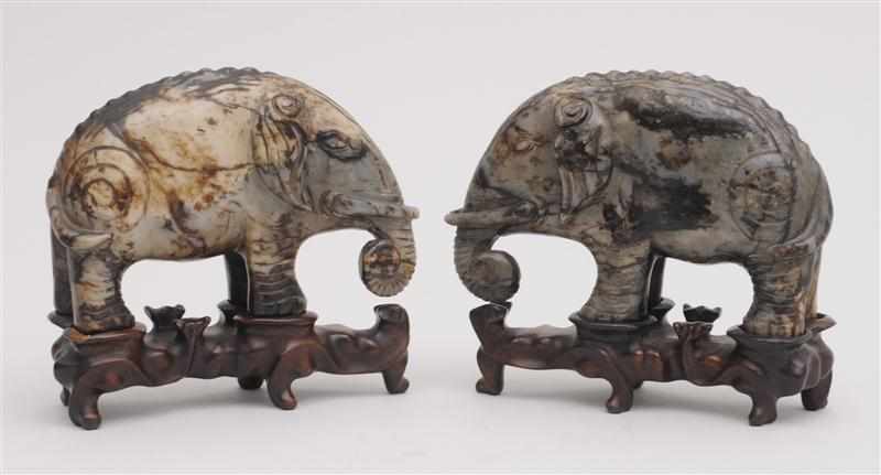 Appraisal: PAIR OF CHINESE CARVED GREEN HARDSTONE ELEPHANT FIGURES Each standing