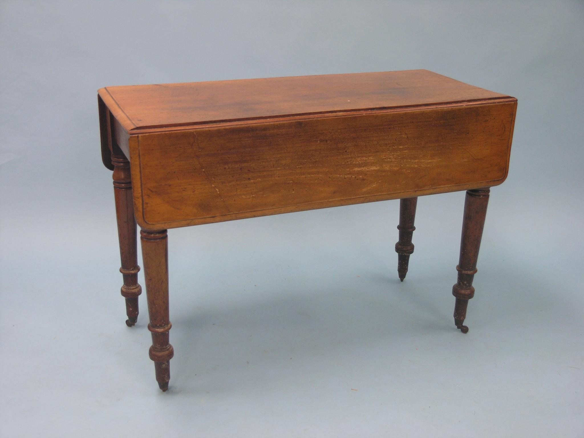 Appraisal: A Victorian mahogany Pembroke table with single frieze drawer on