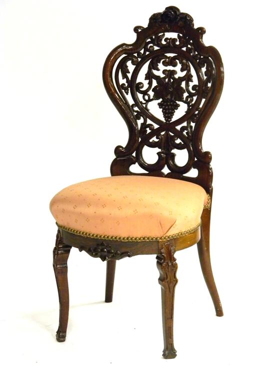 Appraisal: Belter-type Victorian side chair laminated rosewood rose crest grape cluster