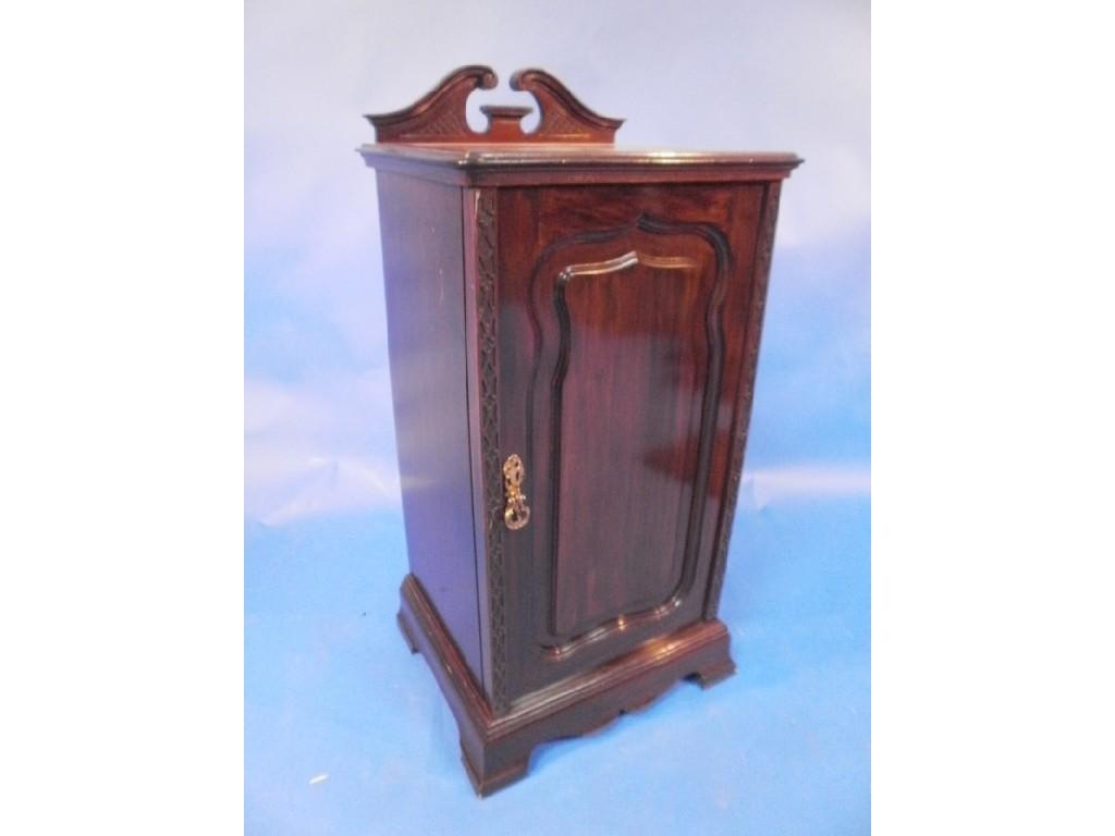 Appraisal: An early thC mahogany bedside cabinet with broken arch pediment