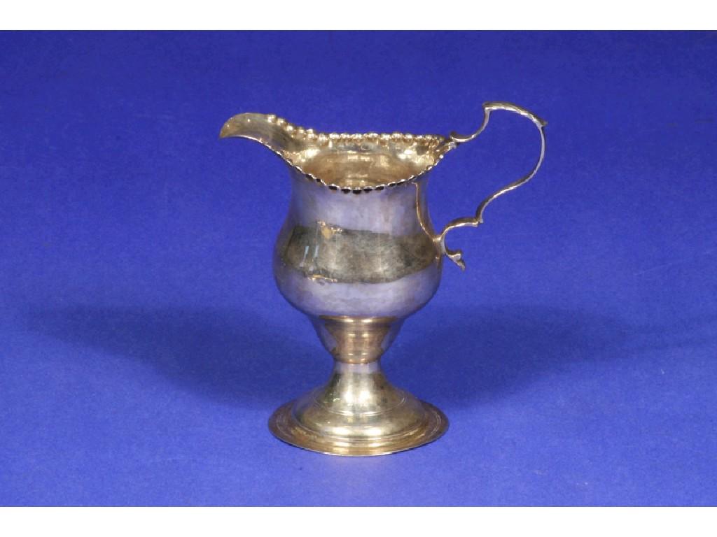 Appraisal: A GEORGE III CREAM JUG of helmet form with crimped