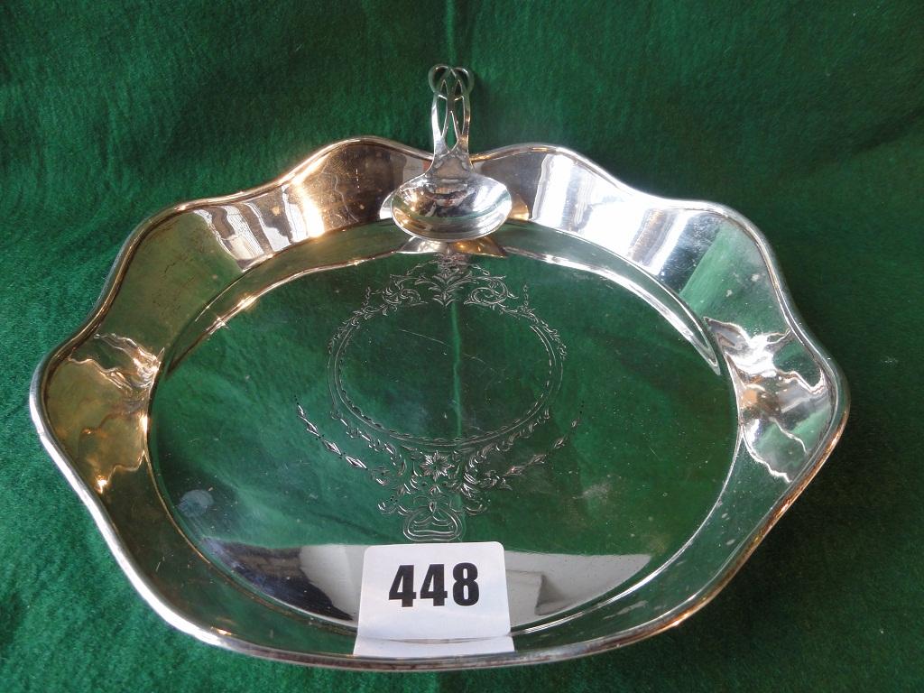 Appraisal: A silver eight sided scrolled edged drinks salver Sheffield made