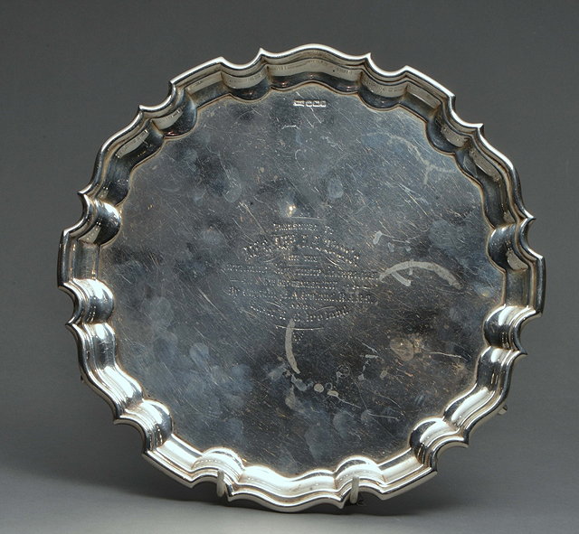 Appraisal: A SILVER PRESENTATION SALVER with piecrust edge by Walker and