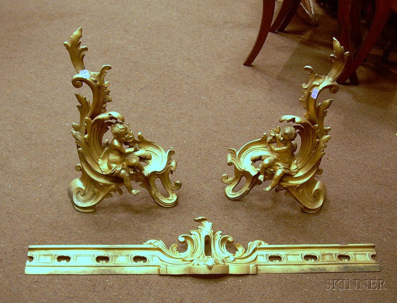 Appraisal: Pair of Gold-painted Rococo-style Cast Iron Cherub Figural Chenet with