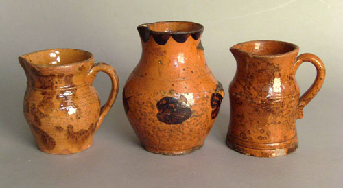 Appraisal: Three redware pitchers th c h h and h