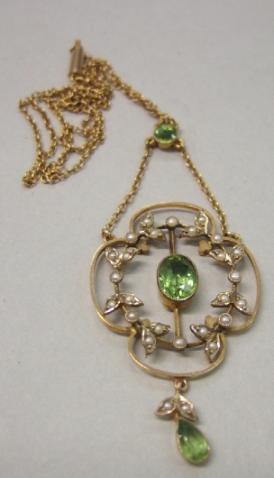 Appraisal: A gold peridot and seed pearl set pendant necklace of