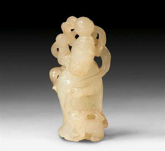 Appraisal: A WHITE JADE FIGURE OF A MAN PLAYING WITH HIS