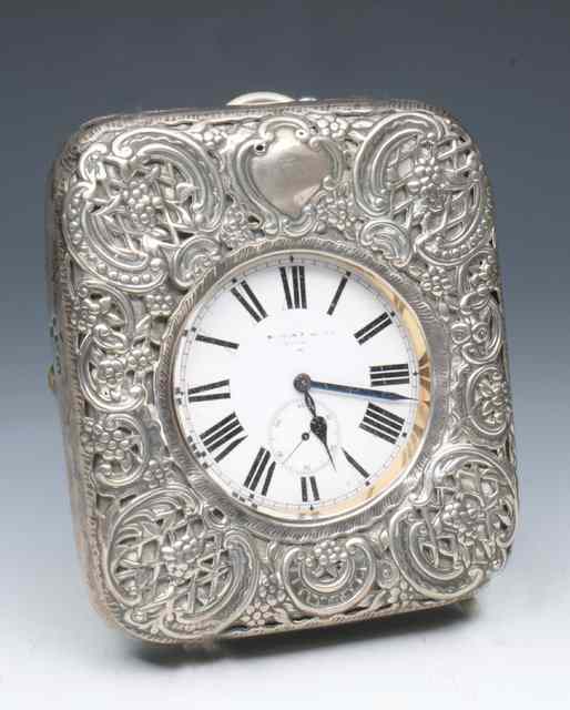 Appraisal: A SILVER FRAMED DESK CLOCK with pressed and pierced scroll