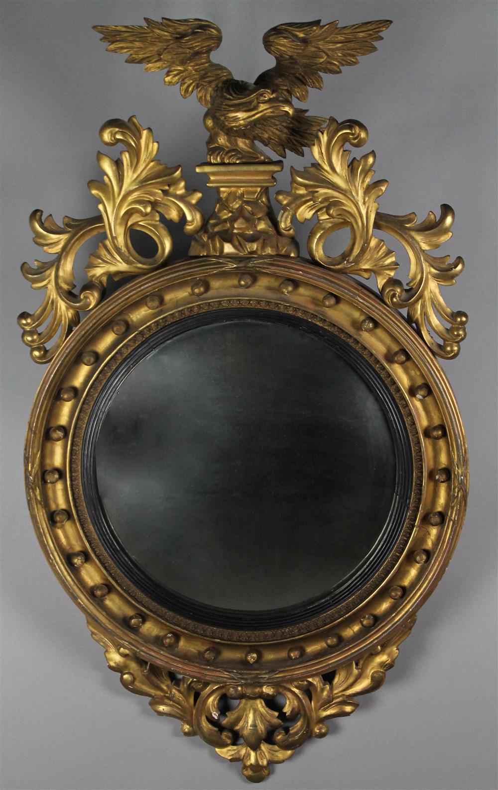 Appraisal: CLASSICAL PART-EBONIZED AND GILTWOOD CONVEX MIRROR English or American having