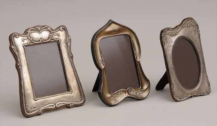 Appraisal: THREE ENGLISH ART NOUVEAU SILVER PICTURE FRAMES Marks for Birmingham