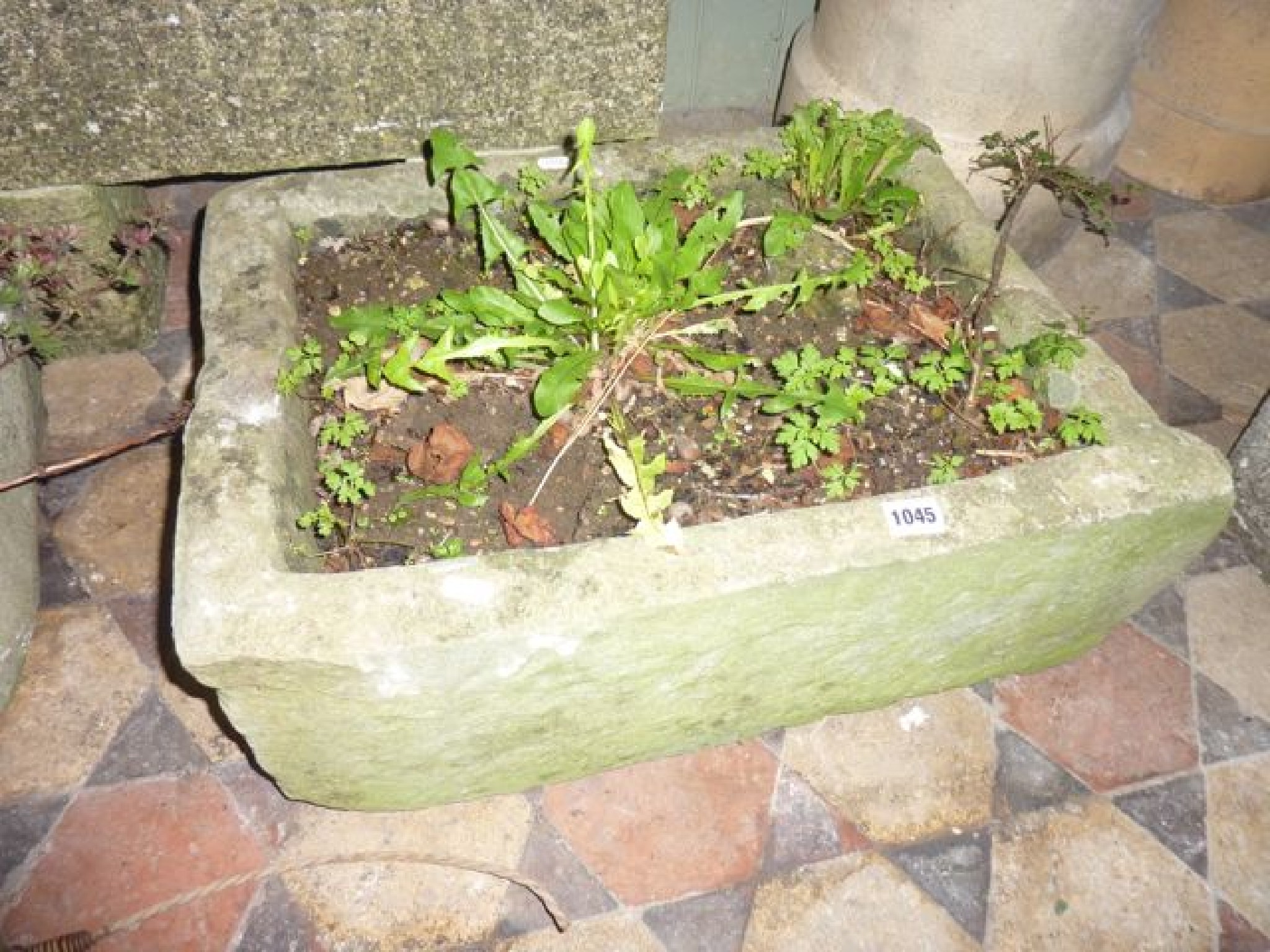 Appraisal: A weathered natural stone trough of rectangular form cm x