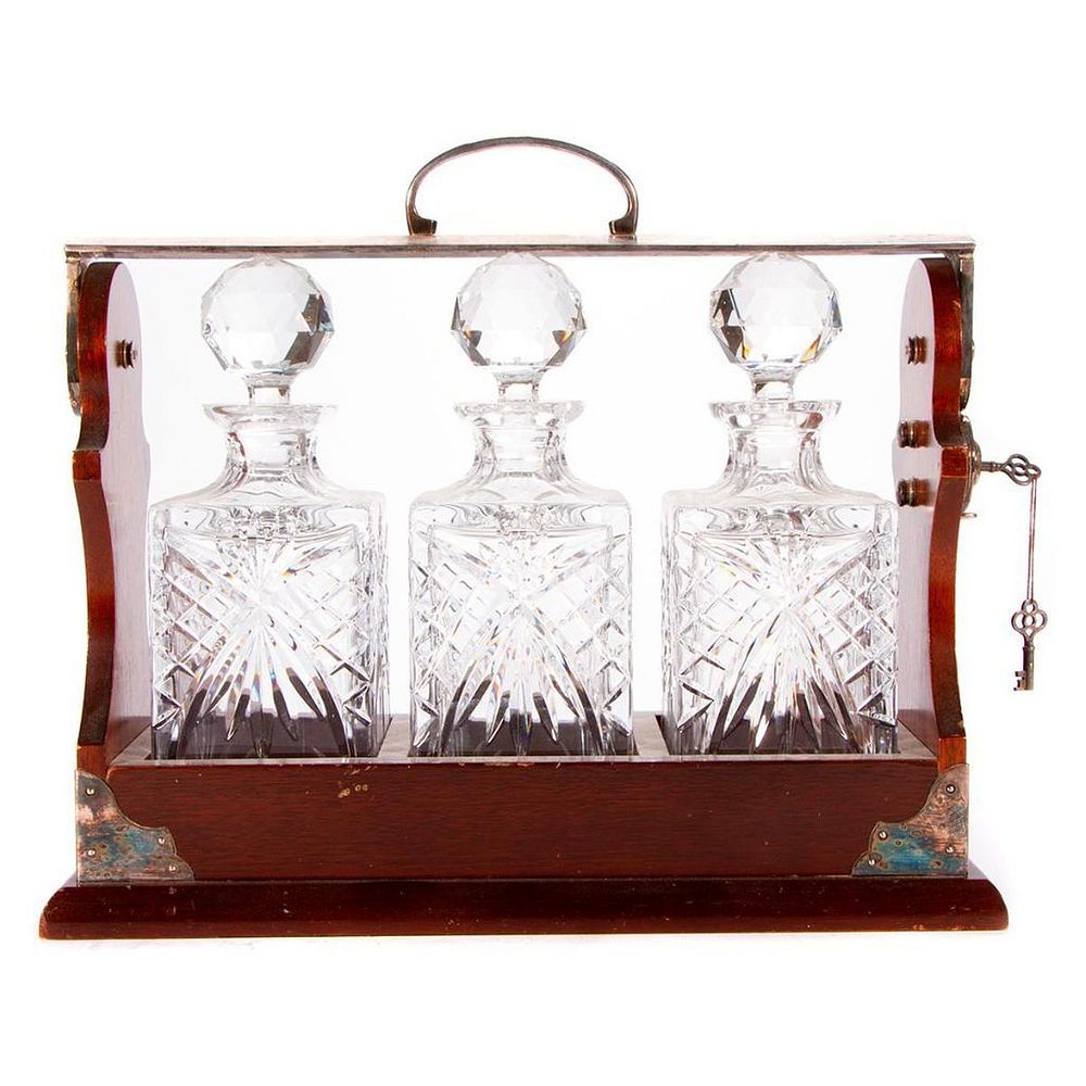 Appraisal: A locking Tantalus decanter set A locking wood silver and