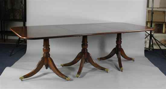 Appraisal: A Regency design mahogany triple pillar dining table on fluted