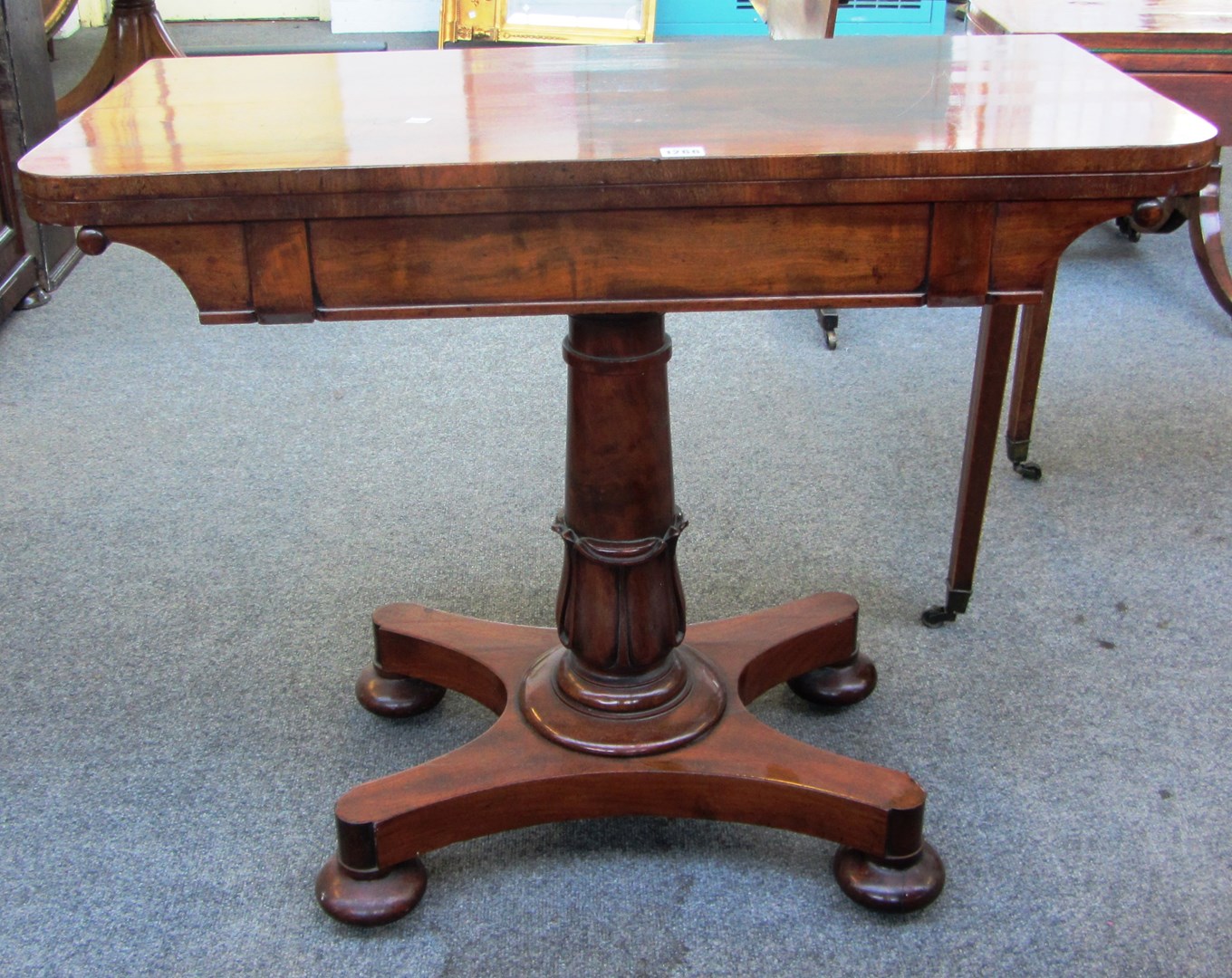 Appraisal: A Victorian mahogany 'D' shaped card table on carved column