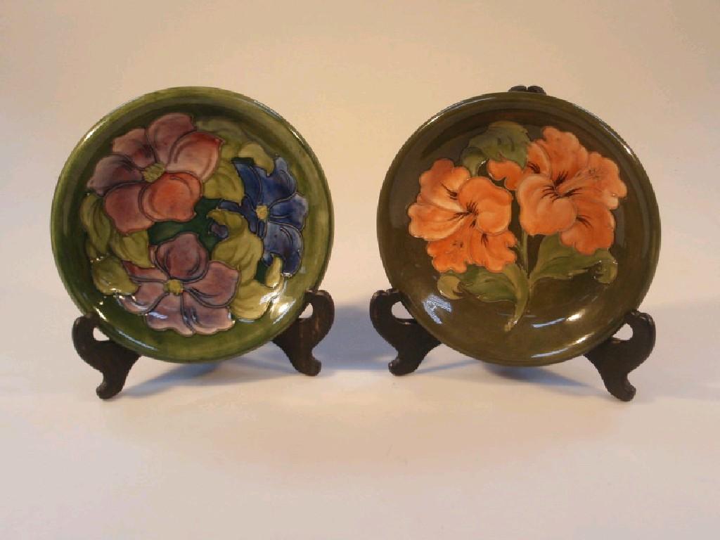 Appraisal: Two Moorcroft circular shallow dishes both decorated with flowers with