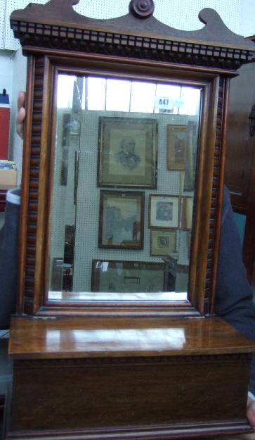 Appraisal: An Edwardian walnut wall mirror with bevelled plate and glove