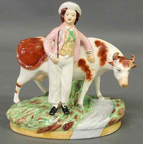 Appraisal: Staffordshire figure of a boy with a standing cow th