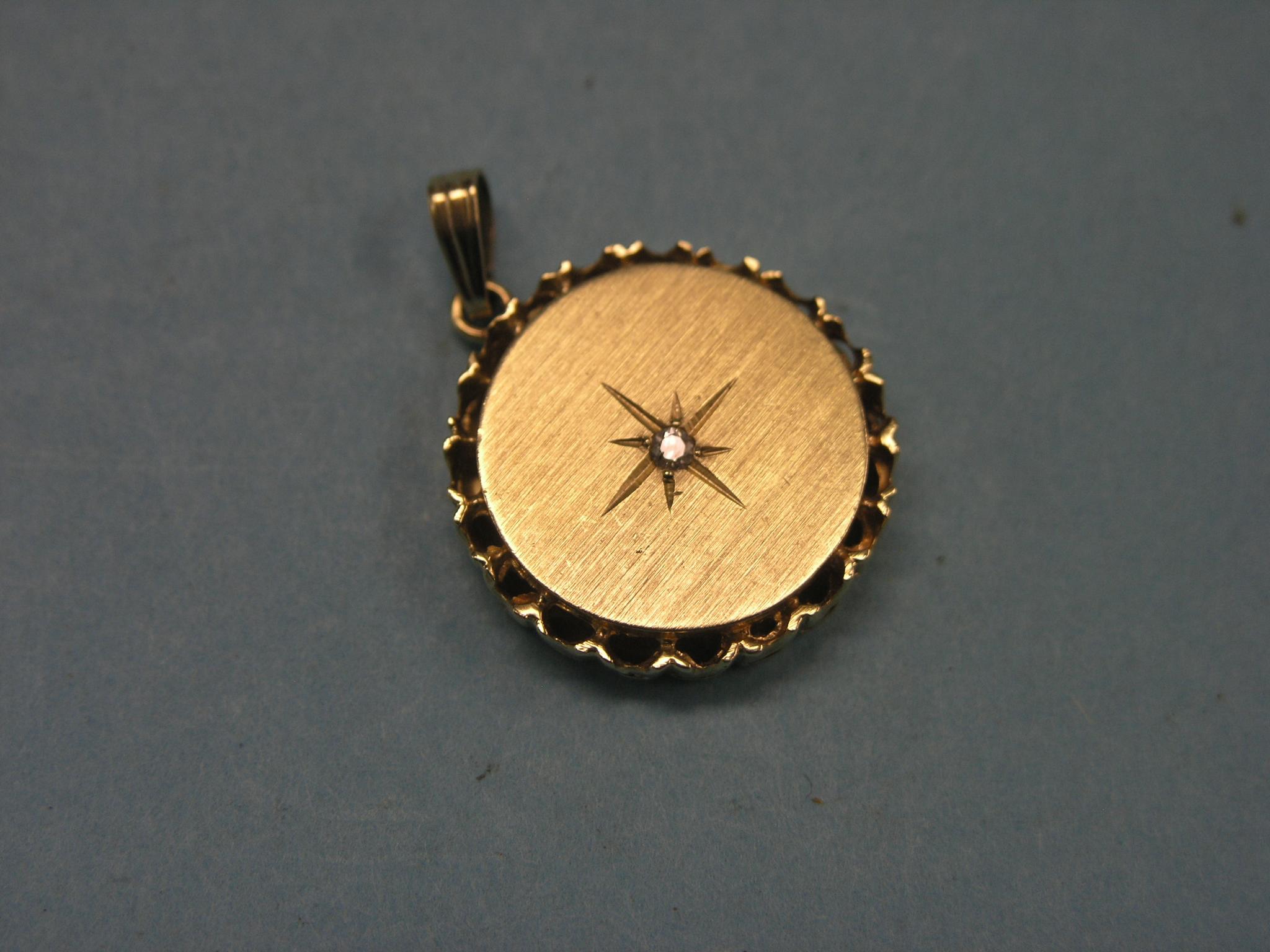 Appraisal: A ct gold pendant circular with inset diamond chip grams