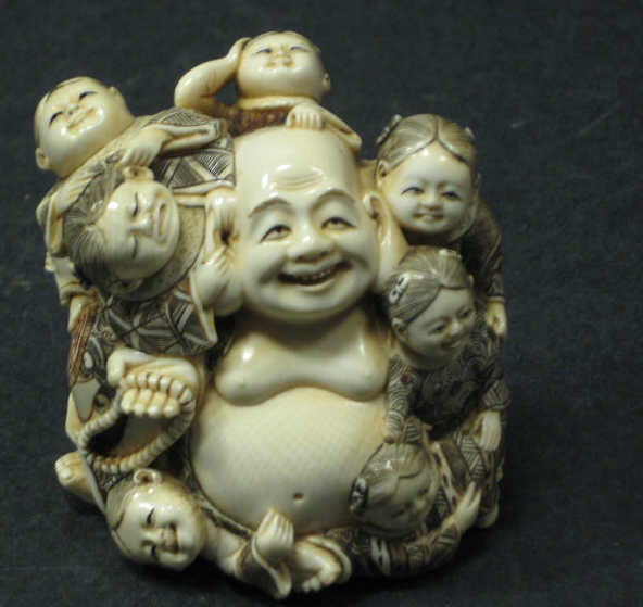 Appraisal: CHINESE CARVED AND INKED FIGURE GROUP Depicting a seated Laughing