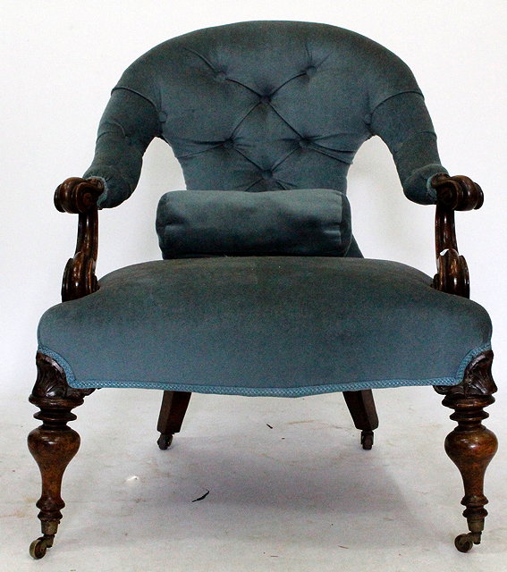 Appraisal: A MAHOGANY CARVED LADIES CHAIR with blue velour and button