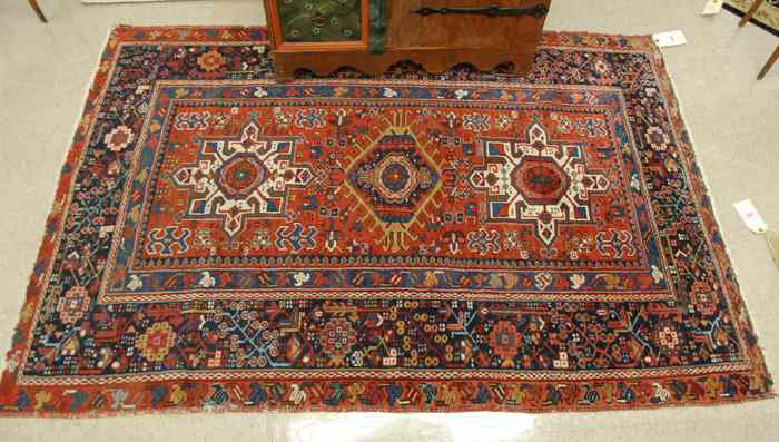 Appraisal: SEMI-ANTIQUE PERSIAN TRIBAL AREA RUG featuring three geometric medallions on