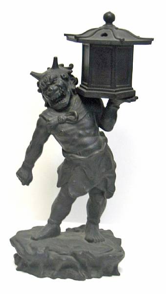 Appraisal: A Japanese cast bronze oni The demon holding up a