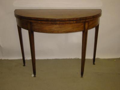 Appraisal: A GEORGIAN MAHOGANY FOLDING CARD TABLE of demi lune form