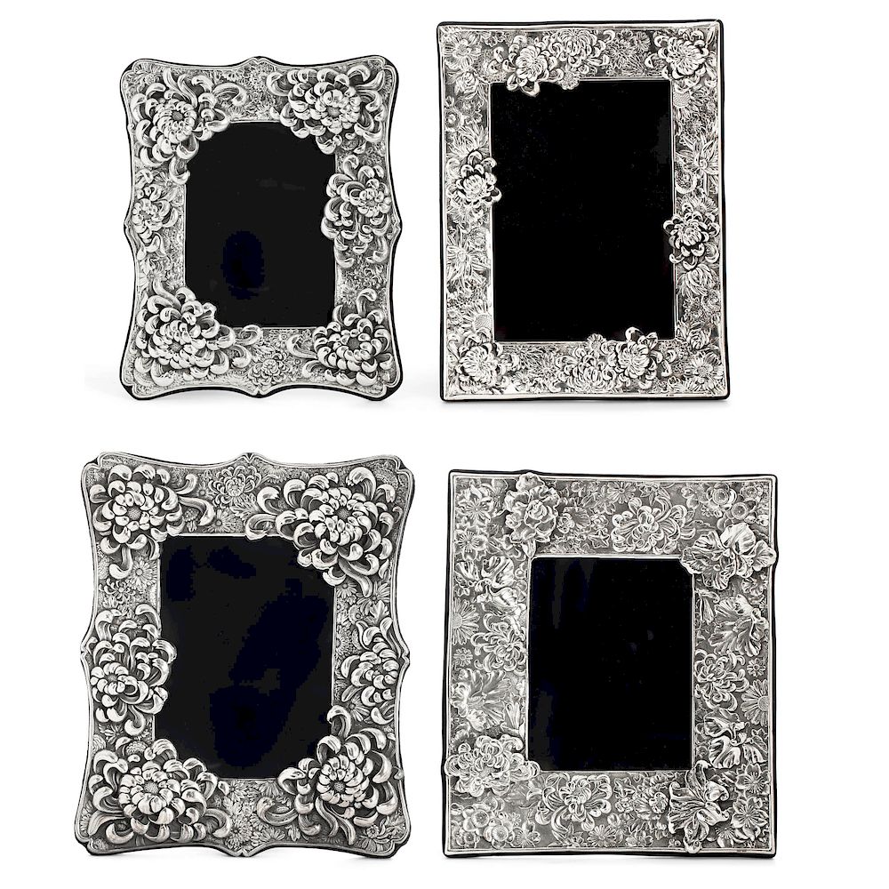 Appraisal: Four silver floral decorated picture frames Four sterling silver floral