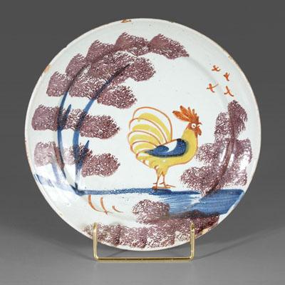 Appraisal: Delft rooster plate standing yellow rooster with sponged manganese tree