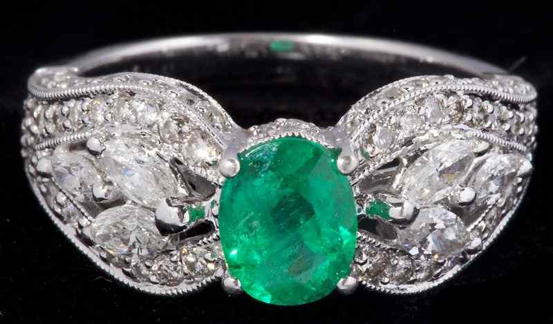 Appraisal: Emerald and Diamond Ringcentering on one oval cut emerald approximately