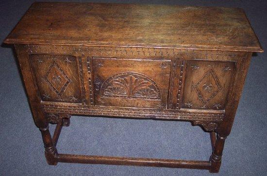 Appraisal: A reproduction oak cupboard the carved panel door over turned