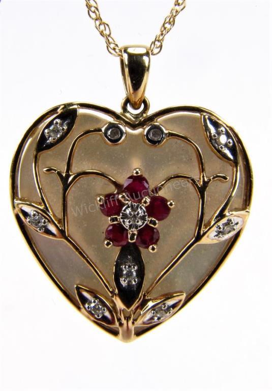 Appraisal: A K yellow gold heart pendant with inlaid heart shape