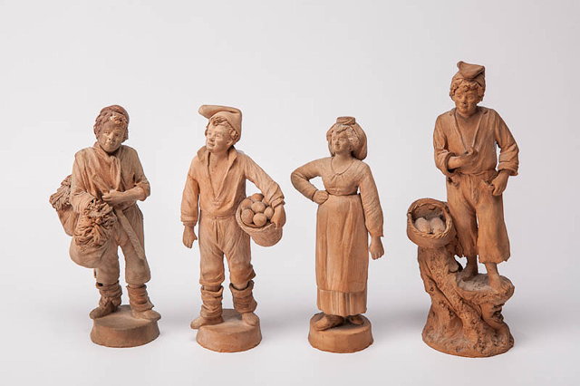 Appraisal: A GROUP OF FIVE BRETON TERRACOTTA FIGURINES of various labourers