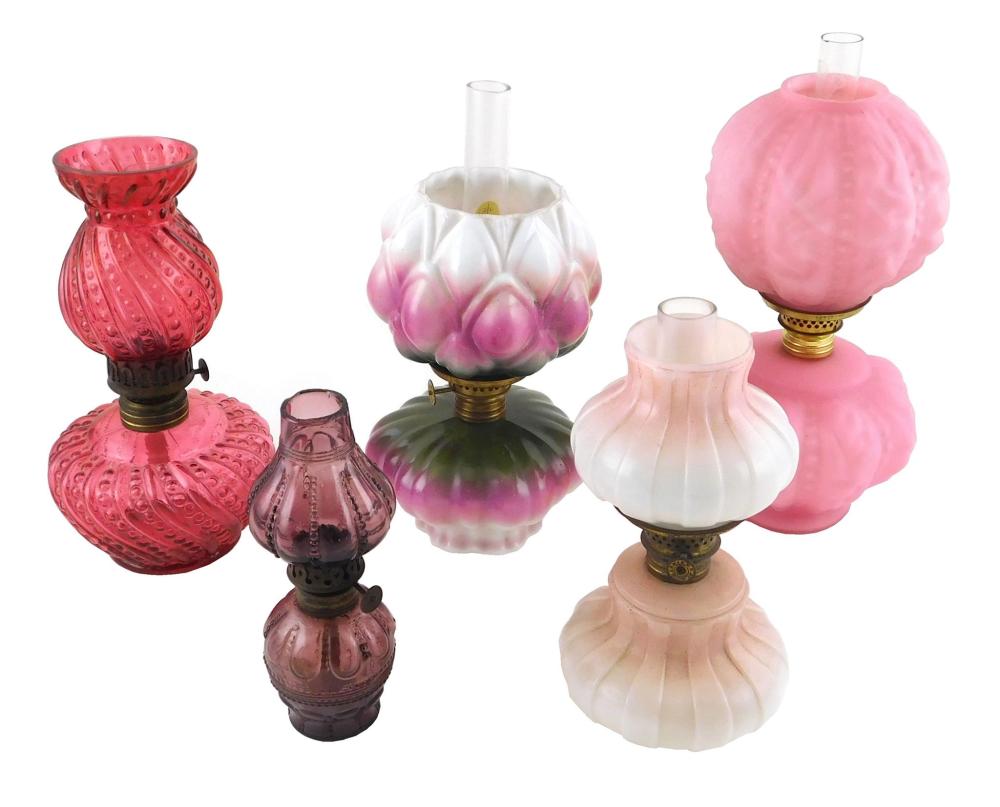 Appraisal: Miniature oil lamps all with pink red or purple glass