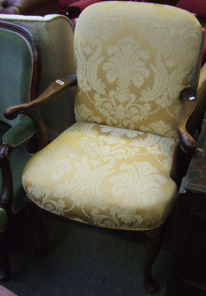 Appraisal: A George II style walnut framed open armchair with padded