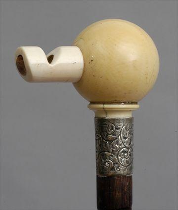 Appraisal: ENGLISH IVORY-HANDLED CARVED WOOD WALKING STICK The spherical handled pierced